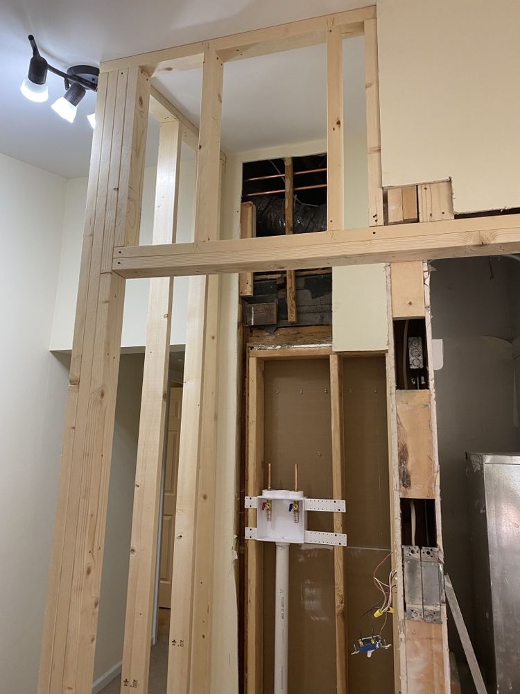 a room that is being remodeled with wooden beams