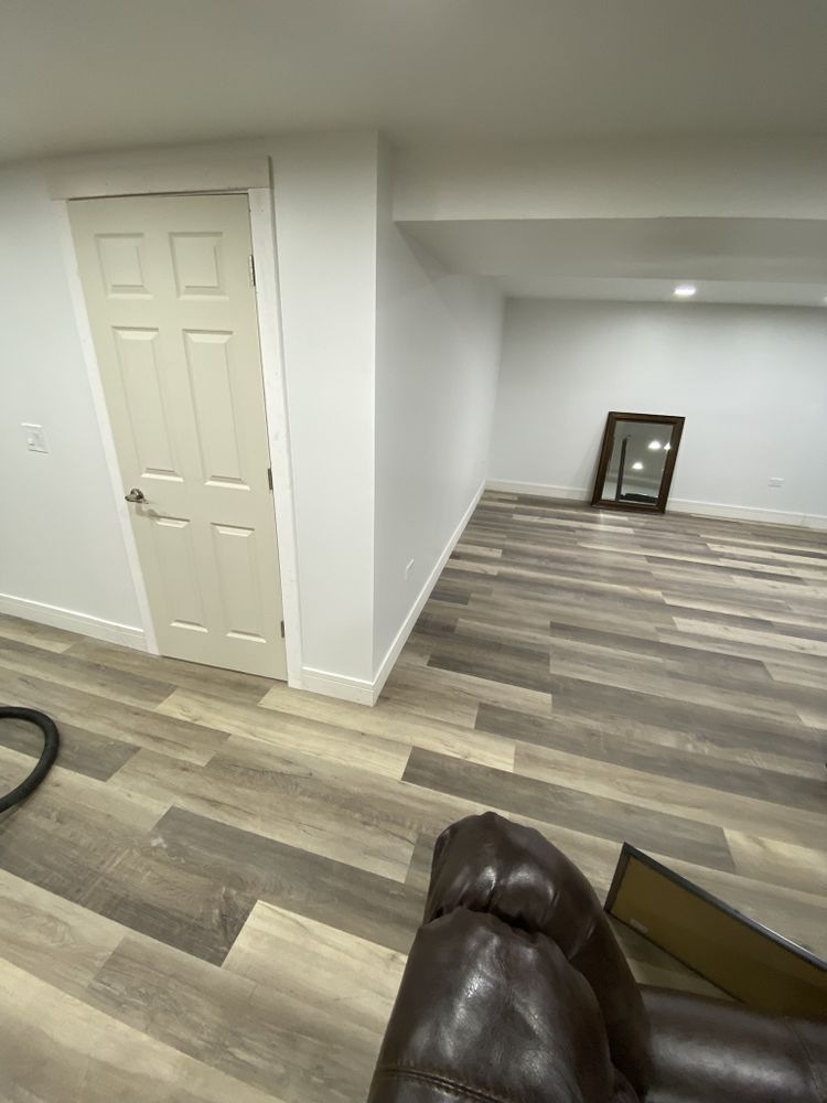 a living room with hardwood floors , a couch , and a door .