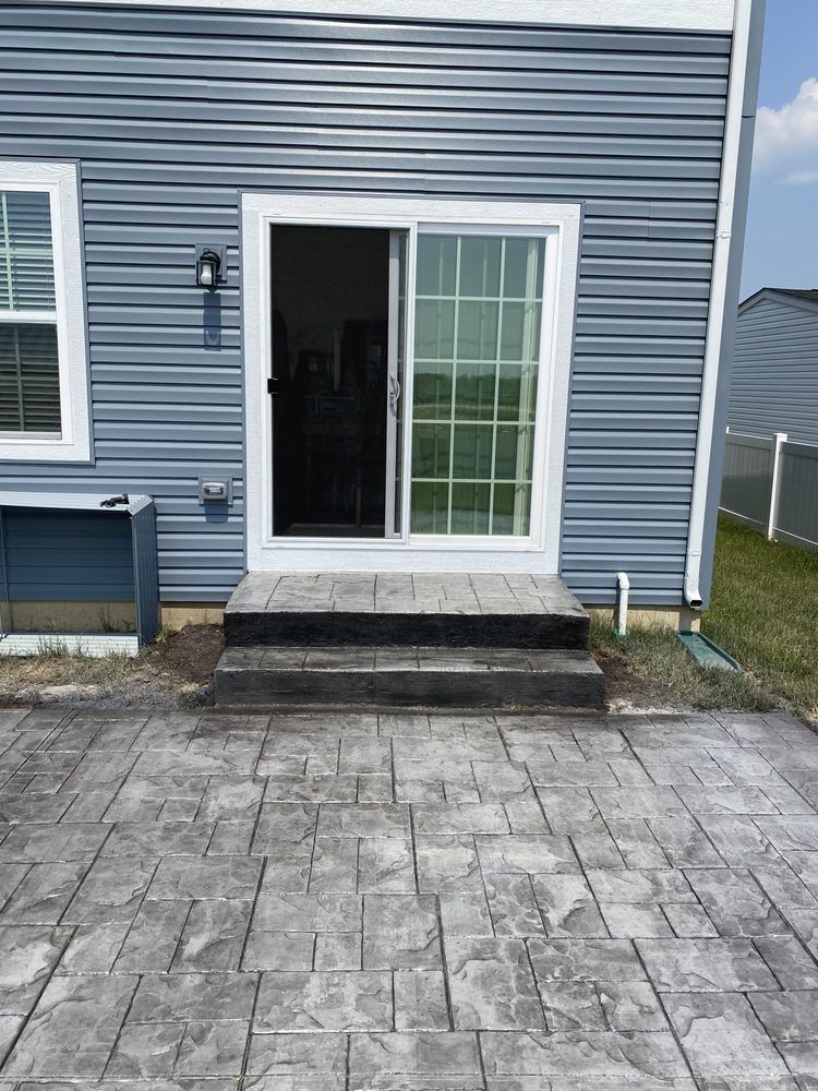 there is a patio in front of a house with a sliding glass door .