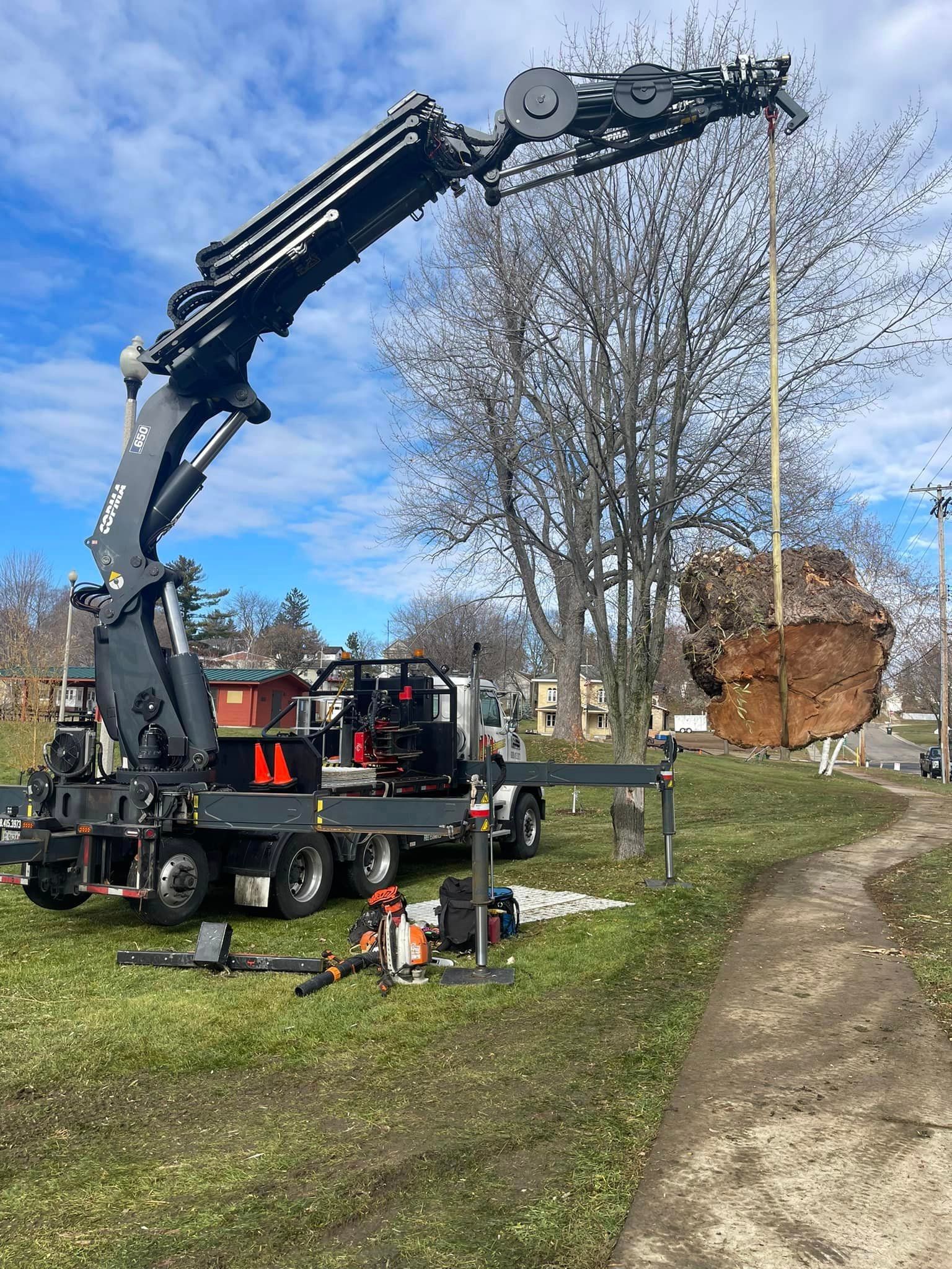 A large rock is being lifted by a crane.