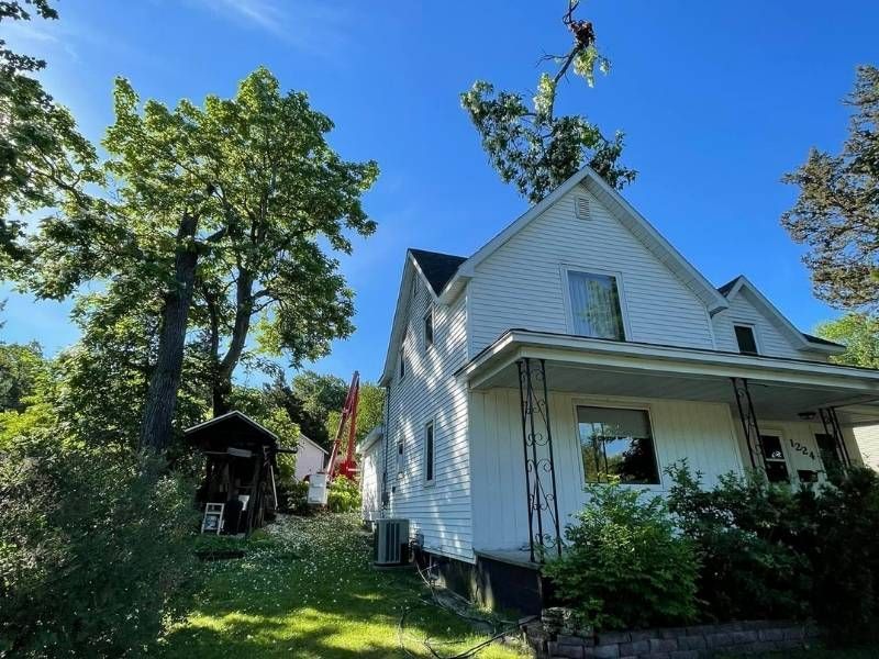 A white house with a tree in front of it