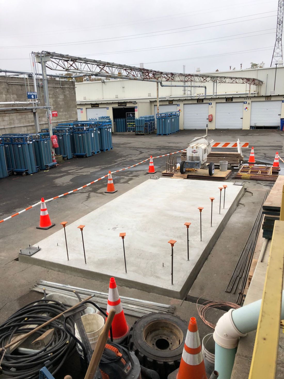 A construction site with a lot of cones and pipes.