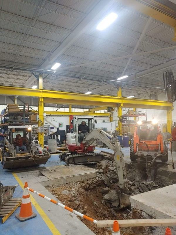 a large yellow excavator is demolishing a large brick building