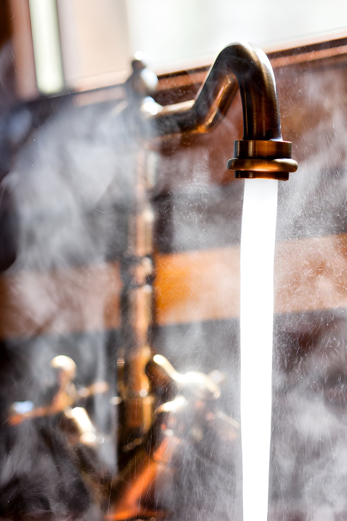 A Close Up Of A Faucet With Steam Coming Out Of It — GPS Plumbing, Drainage & Gasfitting In Dubbo, NSW