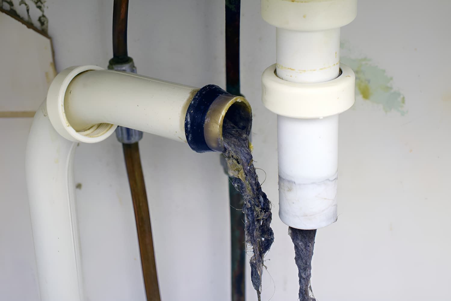 A Close Up Of A Drain Pipe With A Lot Of Waste Coming Out Of It — GPS Plumbing, Drainage & Gasfitting In Dubbo, NSW