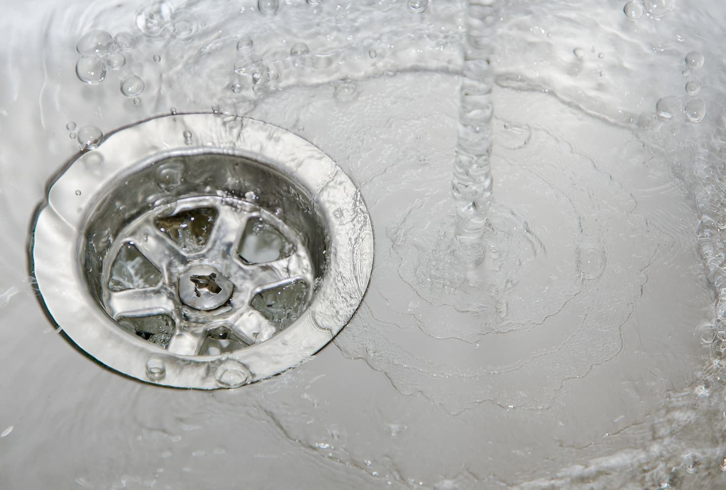 A Sink Drain With Water Running Down It — GPS Plumbing, Drainage & Gasfitting In Dubbo, NSW