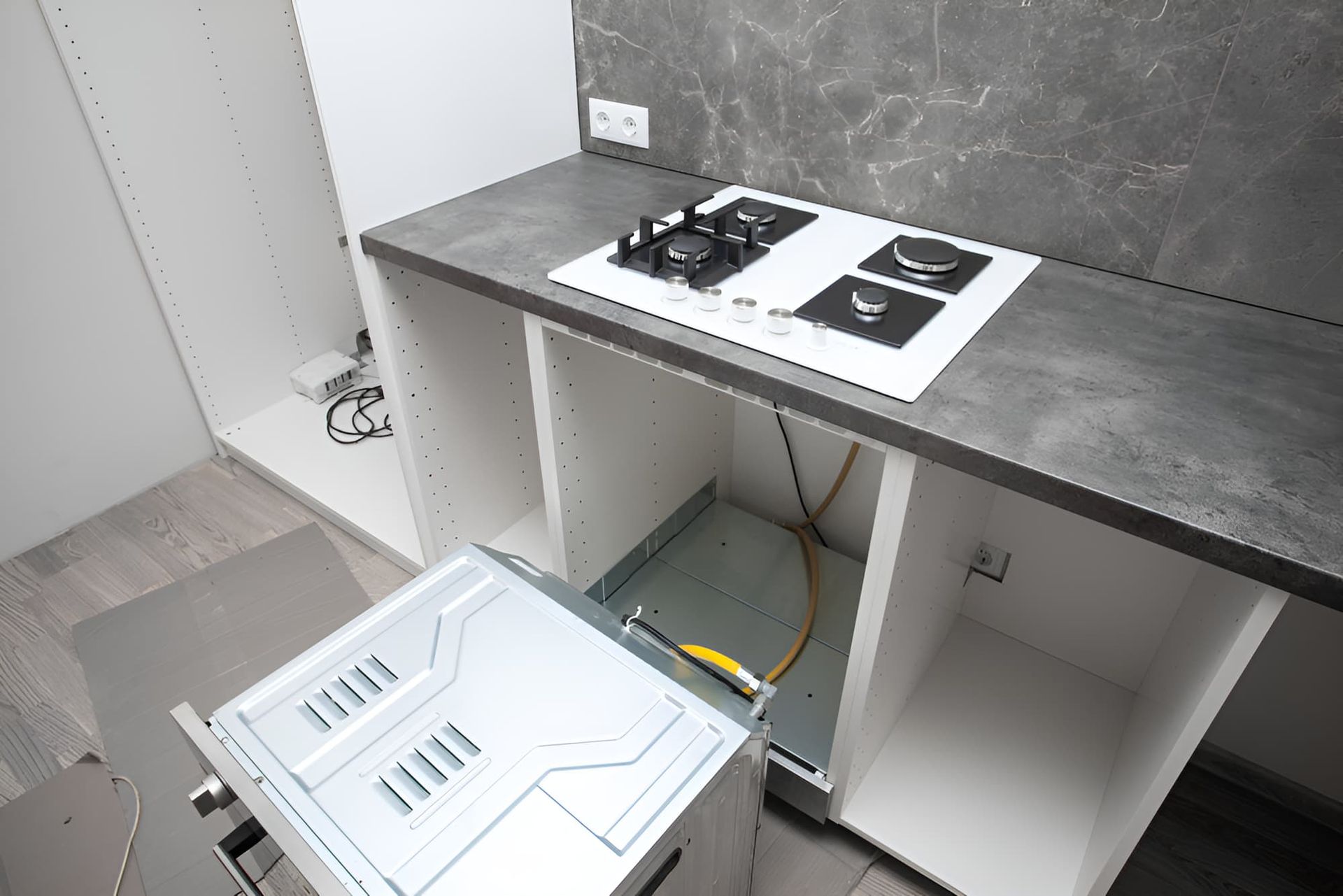 A Kitchen With A Stove Top Oven And A Microwave — GPS Plumbing, Drainage & Gasfitting In Dubbo, NSW