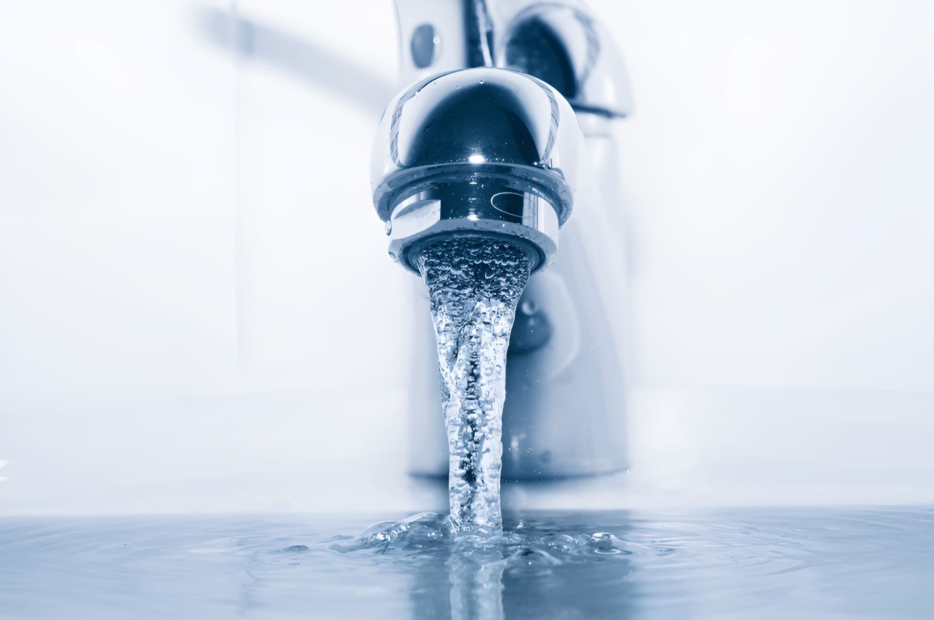 Water Is Pouring From A Faucet Into A Sink — GPS Plumbing, Drainage & Gasfitting In Dubbo, NSW