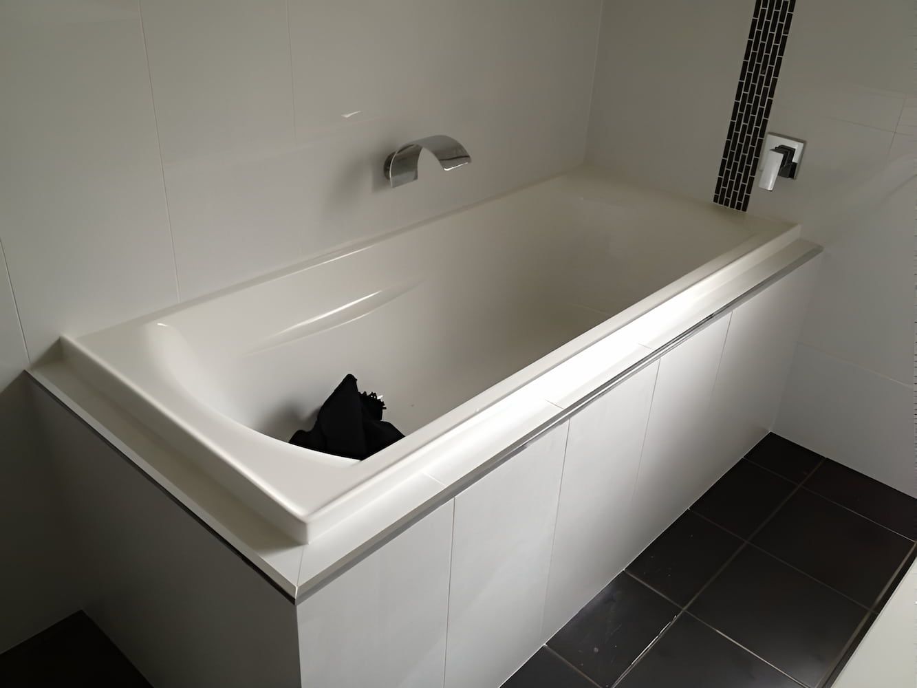 A Bathtub In A Bathroom With A Black Towel In It — GPS Plumbing, Drainage & Gasfitting In Dubbo, NSW