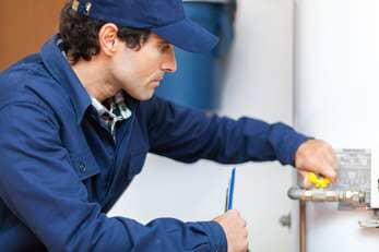 Plumber Repairing an Hot-water Heater — Plumbing Services in Baytown, TX