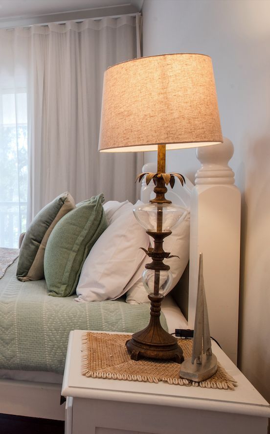 A Lamp is Sitting on a Nightstand Next to a Bed in a Bedroom — Gold Coast Detox and Rehab Services in Gold Coast, QLD