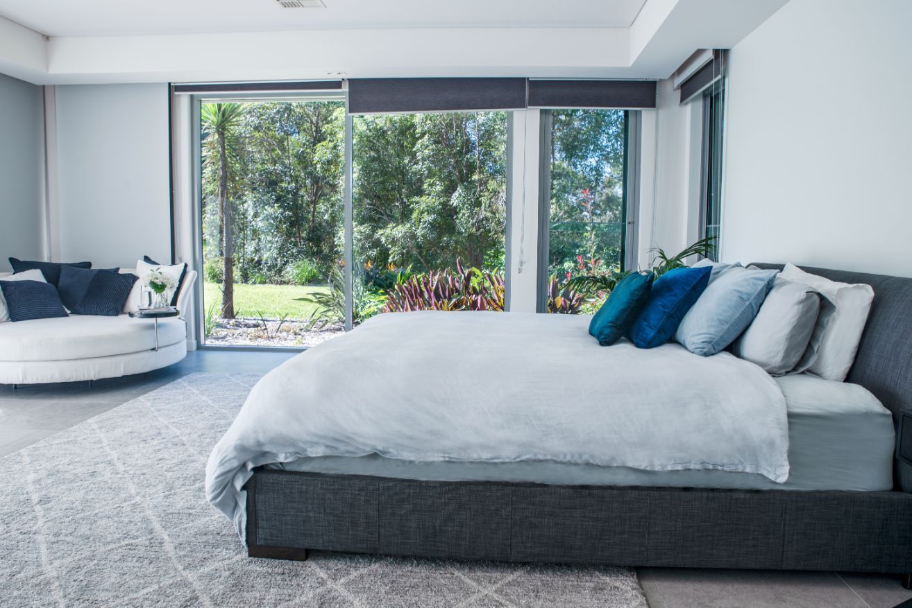 A Bedroom With a Large Bed and a Round Couch — Gold Coast Detox and Rehab Services in Gold Coast, QLD
