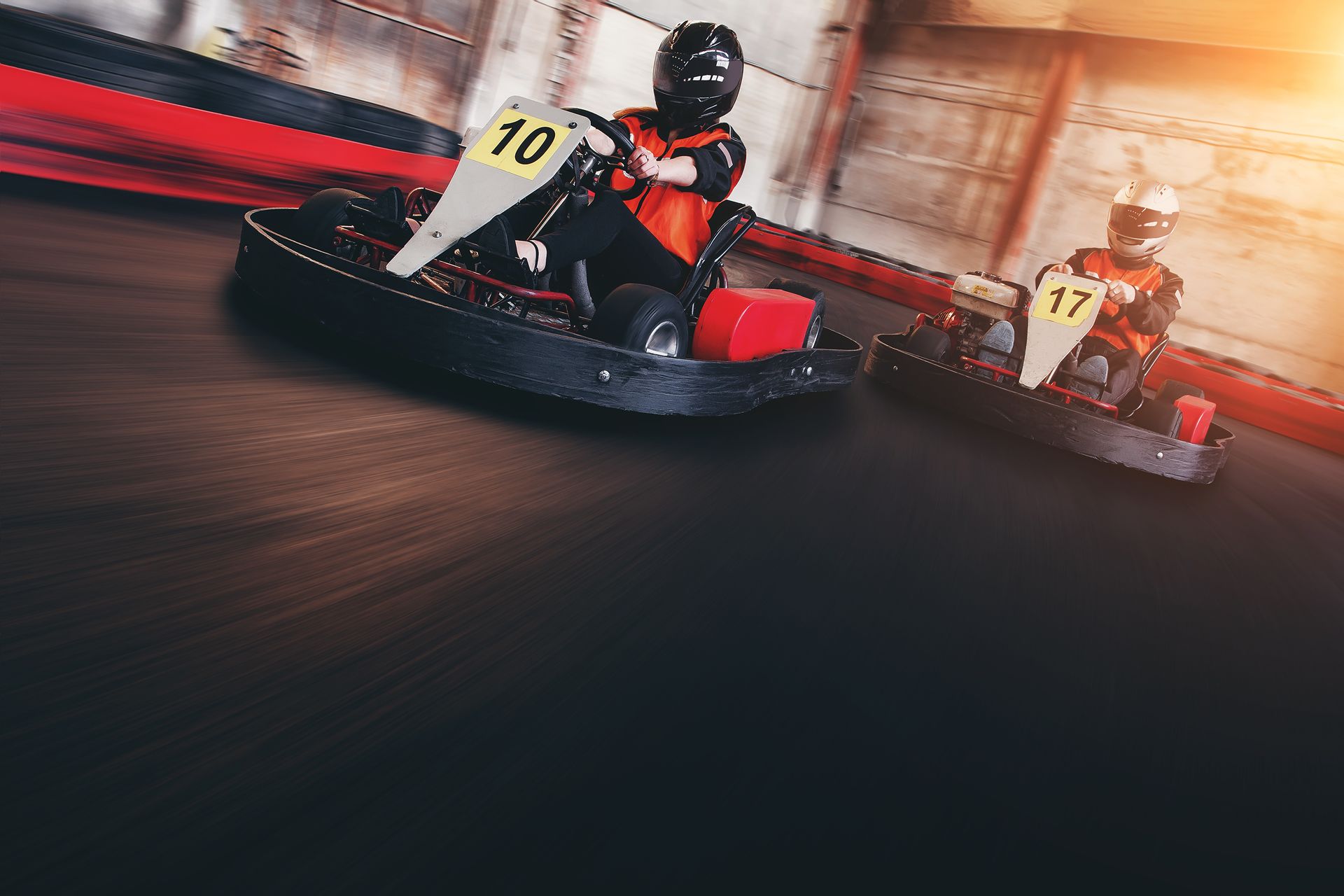 Two People Are Riding Go Karts on a Track — Gold Coast Detox and Rehab Services in Gold Coast, QLD