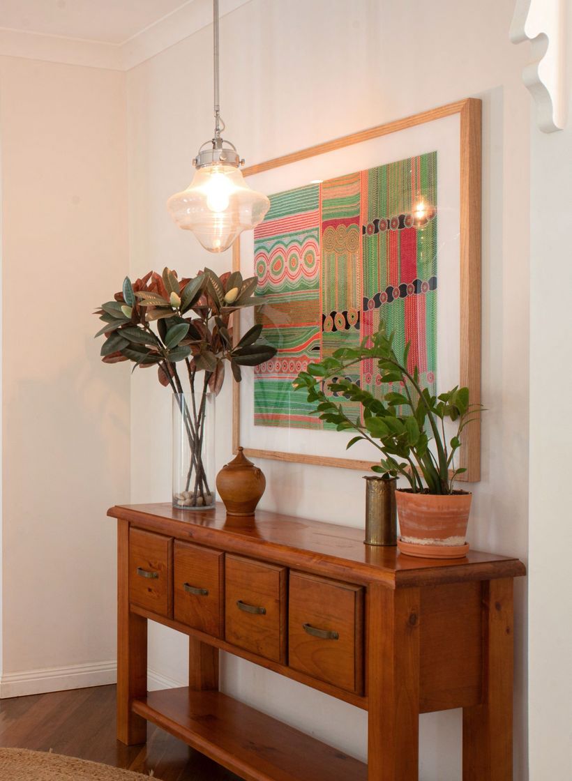 A Wooden Table With Drawers and a Picture on the Wall Above It — Gold Coast Detox and Rehab Services in Gold Coast, QLD