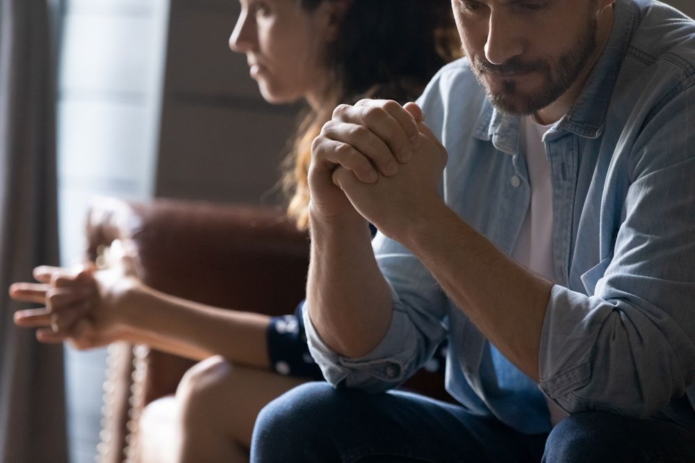 Two People Sitting On A Couch Holding Hands— Gold Coast Detox and Rehab Services in Gold Coast, QLD