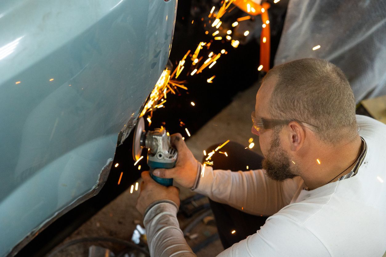 A Man is Grinding the Side of a Car With a Grinder — Gold Coast Detox and Rehab Services in Gold Coast, QLD