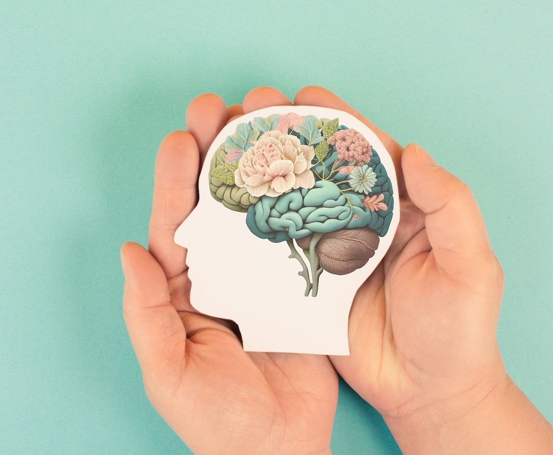 A Person is Holding a Drawing of a Brain With Flowers in It — Gold Coast Detox and Rehab Services in Gold Coast, QLD