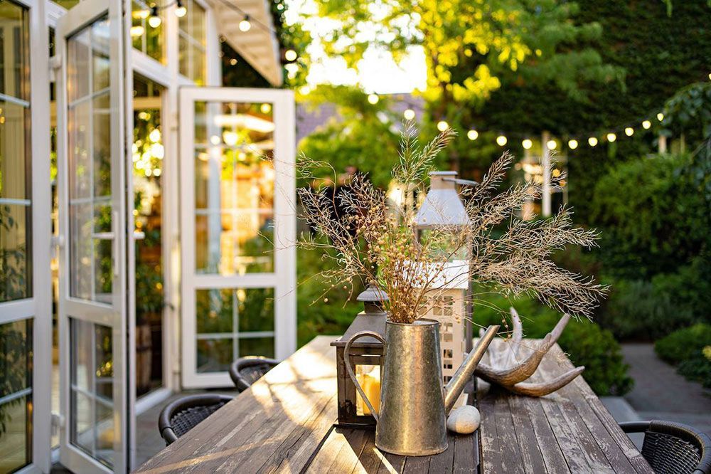 A Wooden Table With A Vase Of Flowers On It In A Garden — Gold Coast Detox and Rehab Services in Gold Coast, QLD