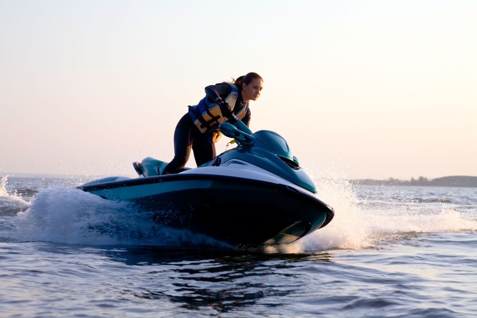 A Woman is Riding a Jet Ski in the Water — Gold Coast Detox and Rehab Services in Gold Coast, QLD