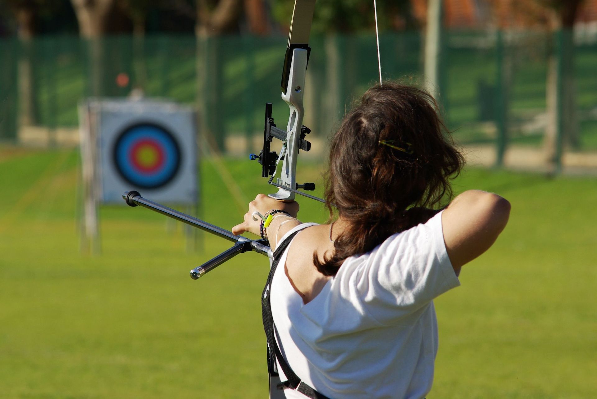 A Back of Archery Athlete Woman Aiming at a Target in the Distance — Gold Coast Detox and Rehab Services in Gold Coast, QLD