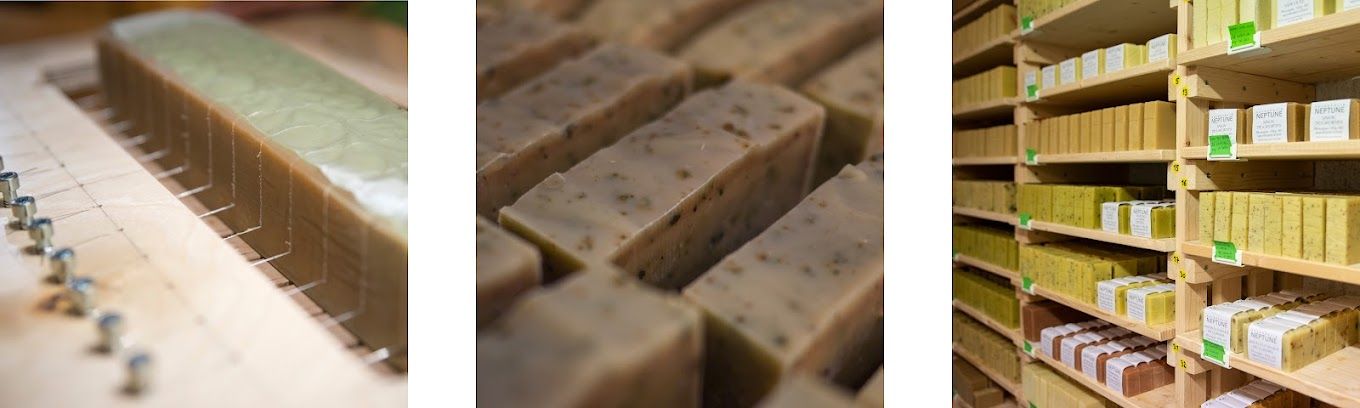 Du savon artisanal est coupé, empilé et rangé sur des étagères.