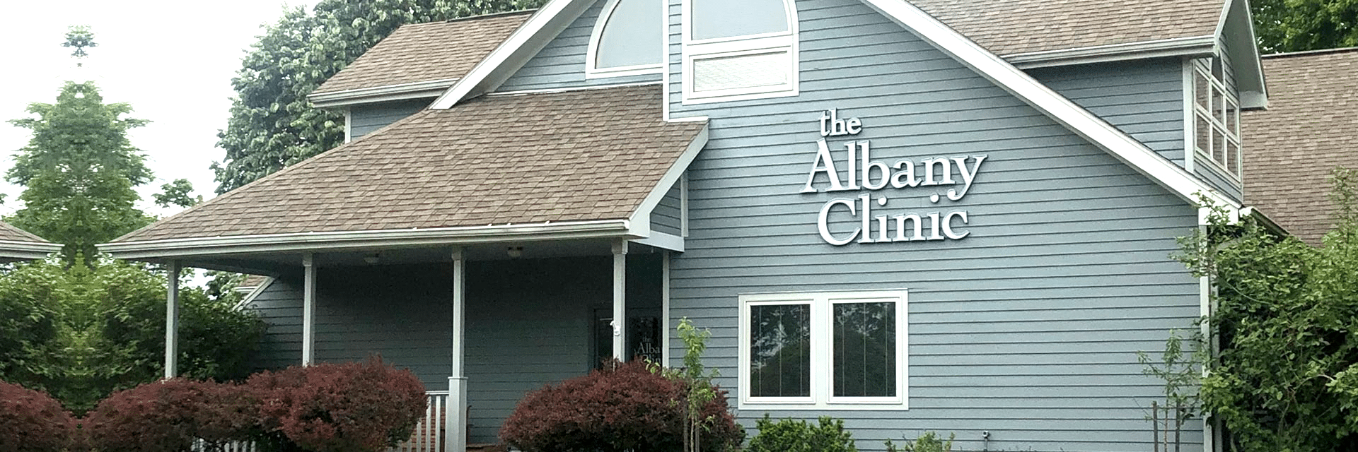a house with a sign that says the albany clinic