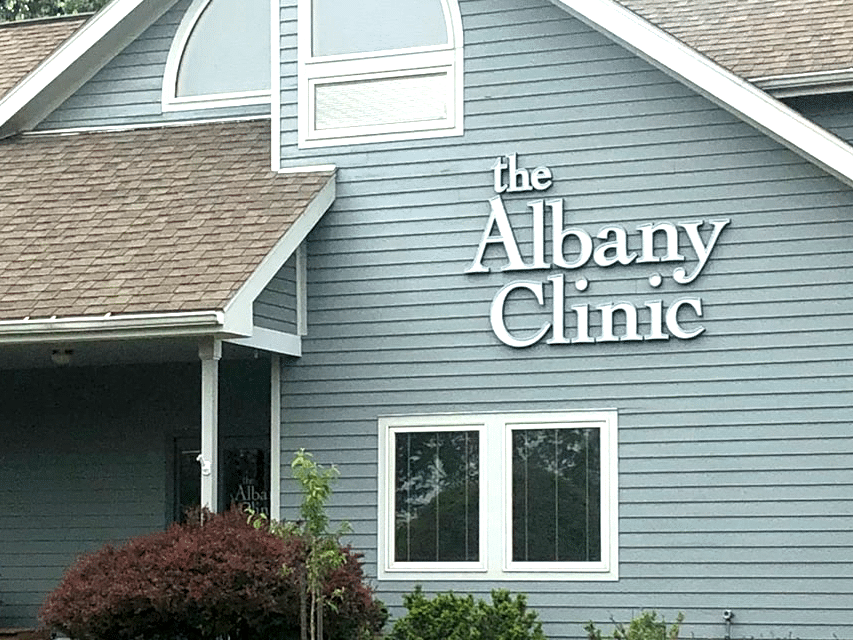 a house with a sign that says the albany clinic