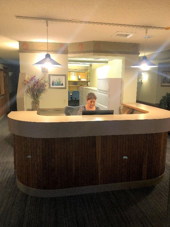 a woman sits at a desk in front of a computer at the albany clinic in carbondale Illinois