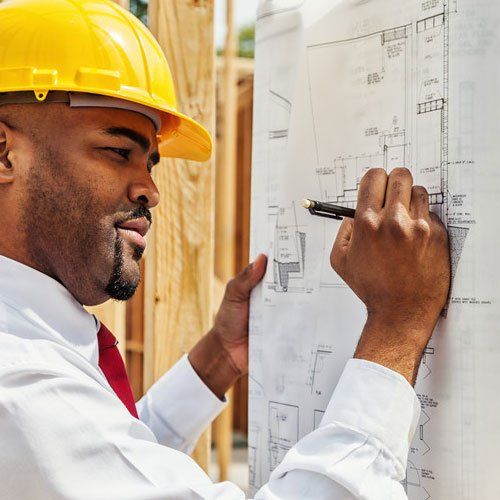 Worker reading blueprints on site