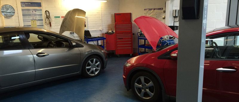 Two cars in the garage for repairs and servicing in Edinburg