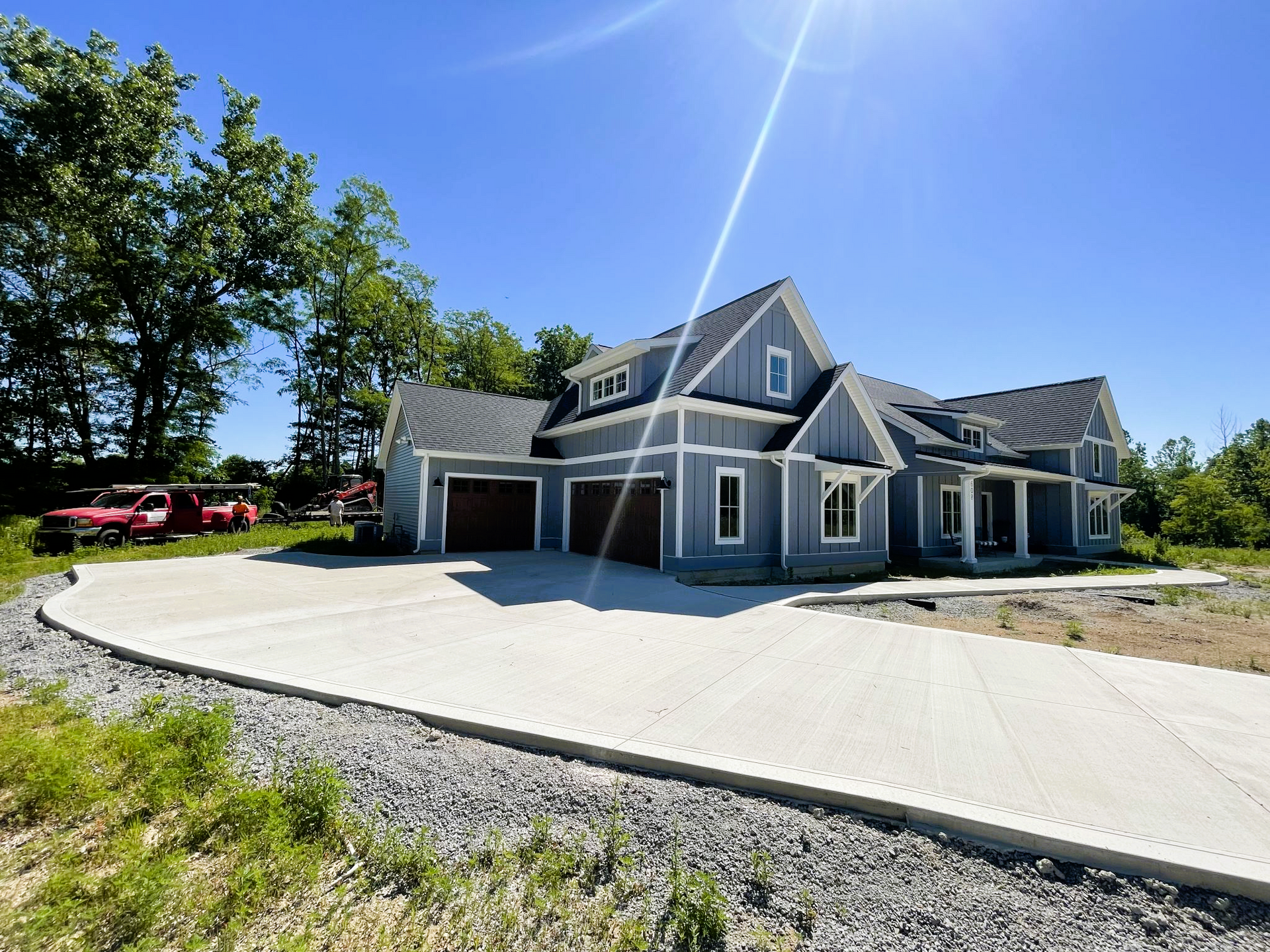 A large house with a concrete driveway in front of it