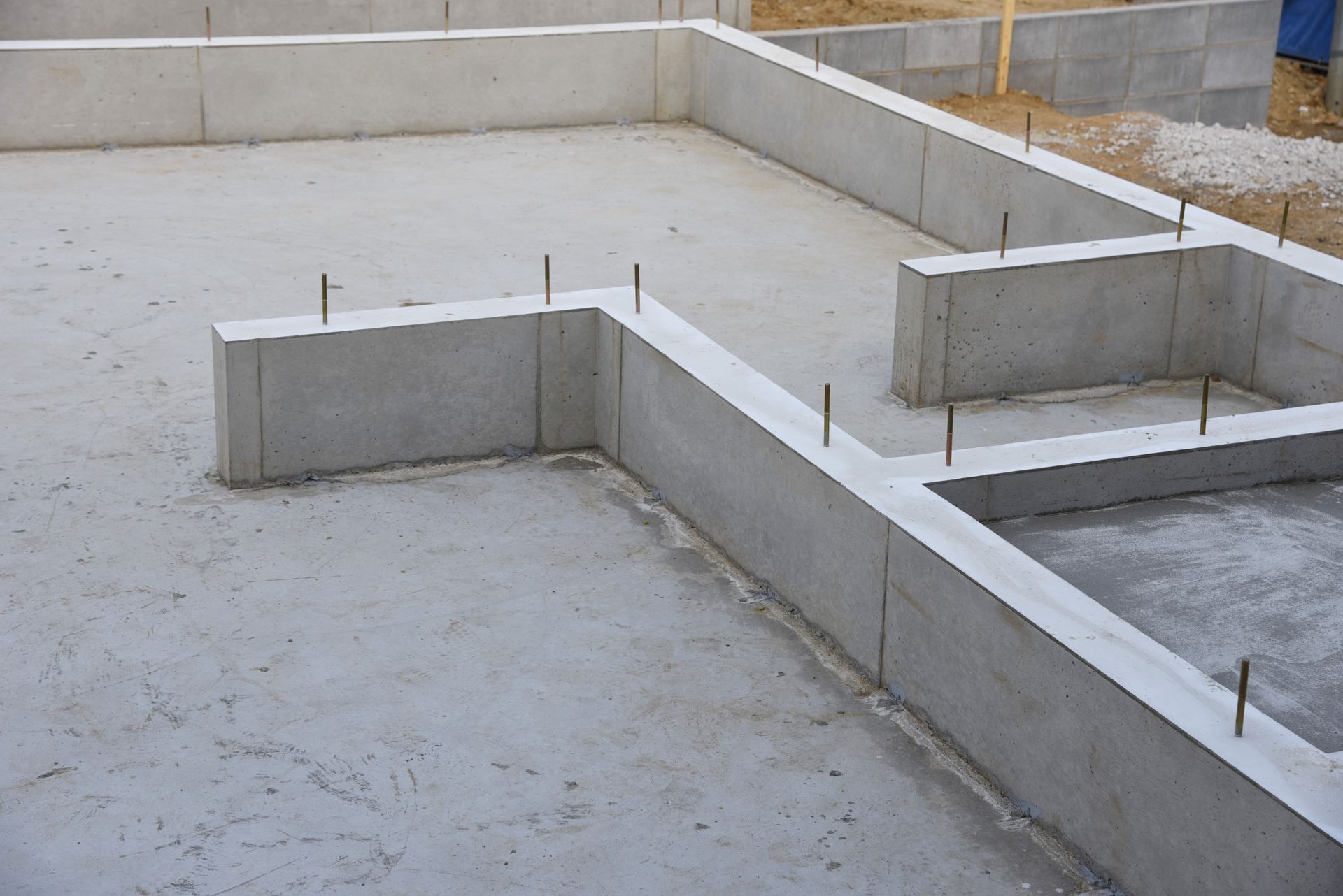 A concrete foundation for a house is being built.