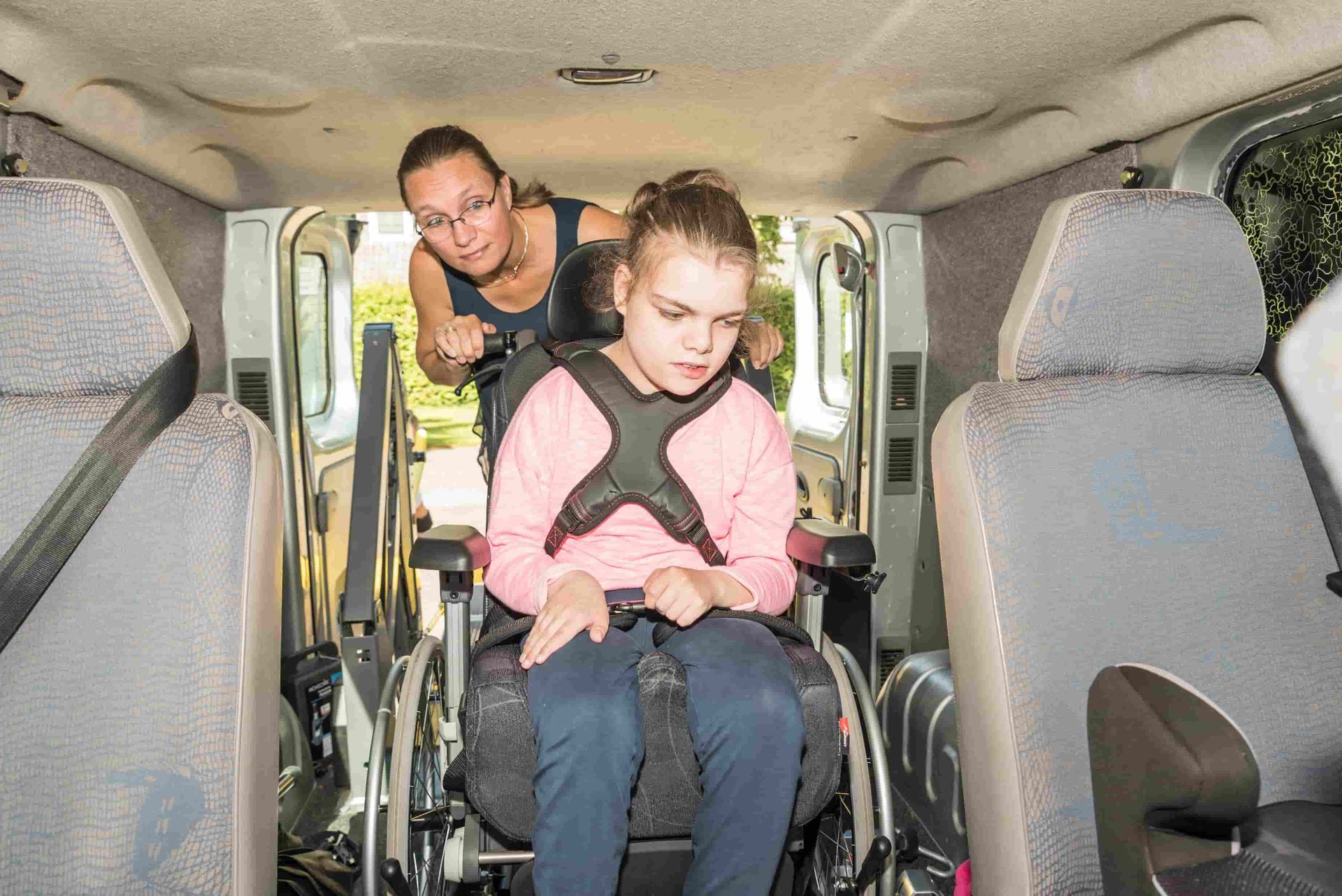 Woman Assisting Young Girl in Wheelchair Out of Van — Active Lifestyle Supports In Shellharbour, NSW