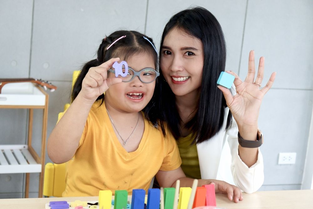 Woman With a Young Girl Holding Toys — Active Lifestyle Supports In Tullimbar, NSW