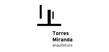A black and white logo for torres miranda arquitetura