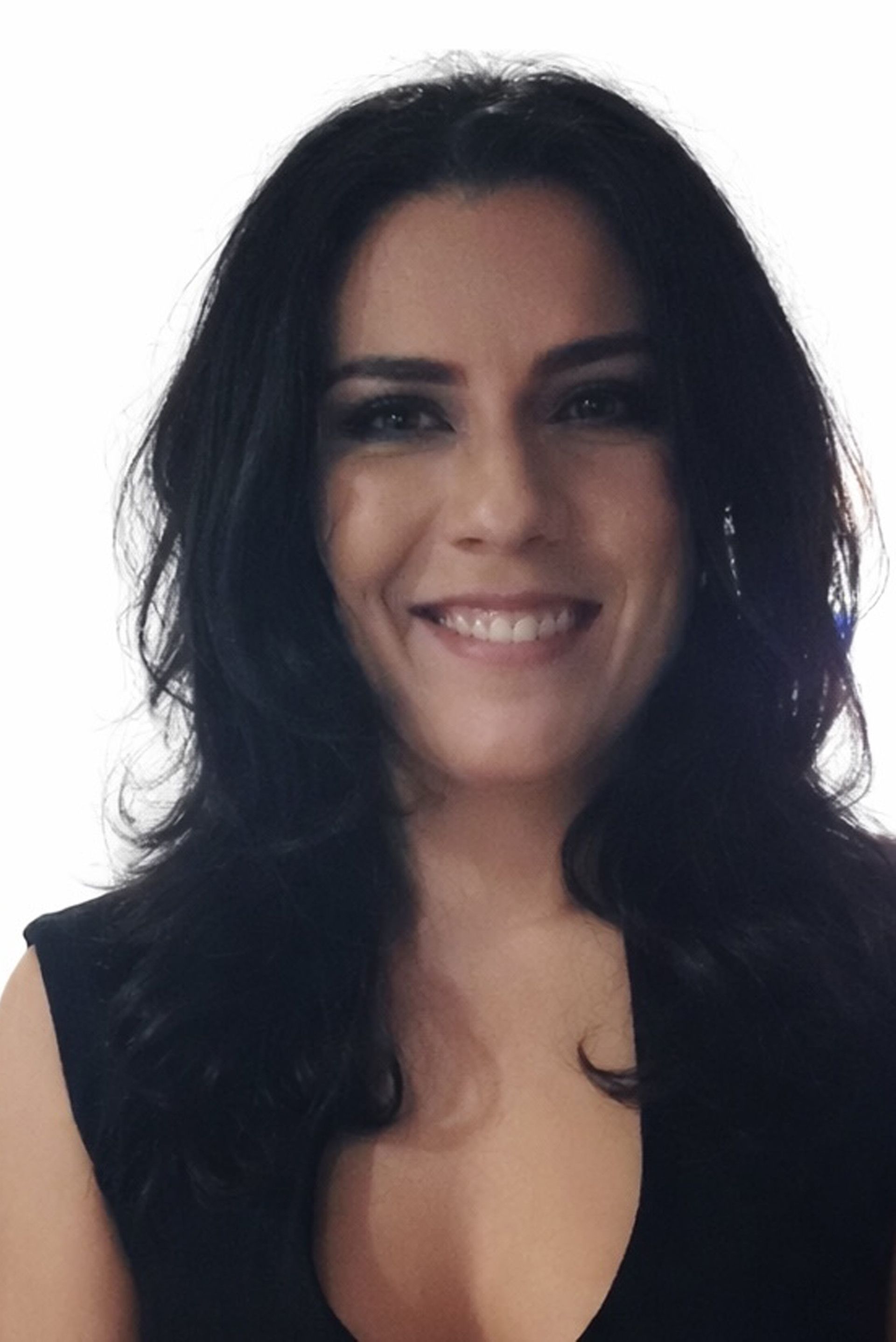 Woman with black hair smiles, wearing a black sleeveless top, against a white background.