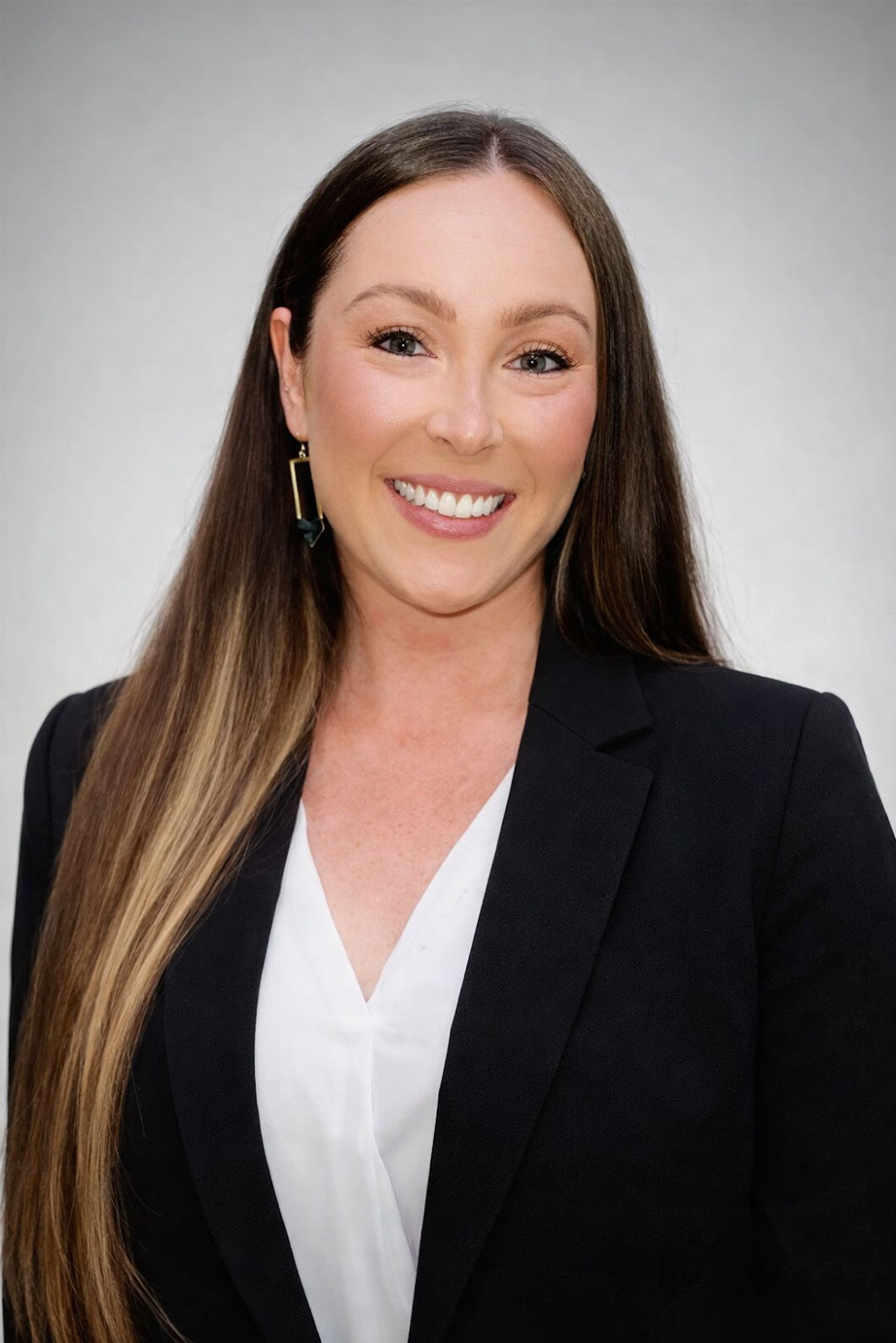 Silhouette of a person with curly hair, glasses, and a collared shirt, facing to the side.