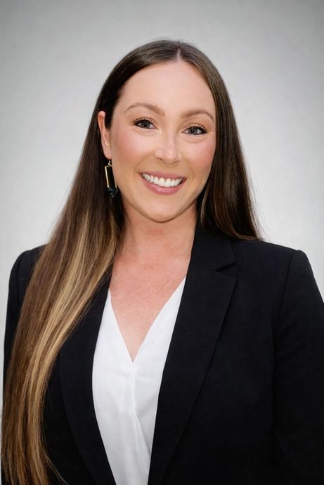 Silhouette of a person with curly hair, glasses, and a collared shirt, facing to the side.