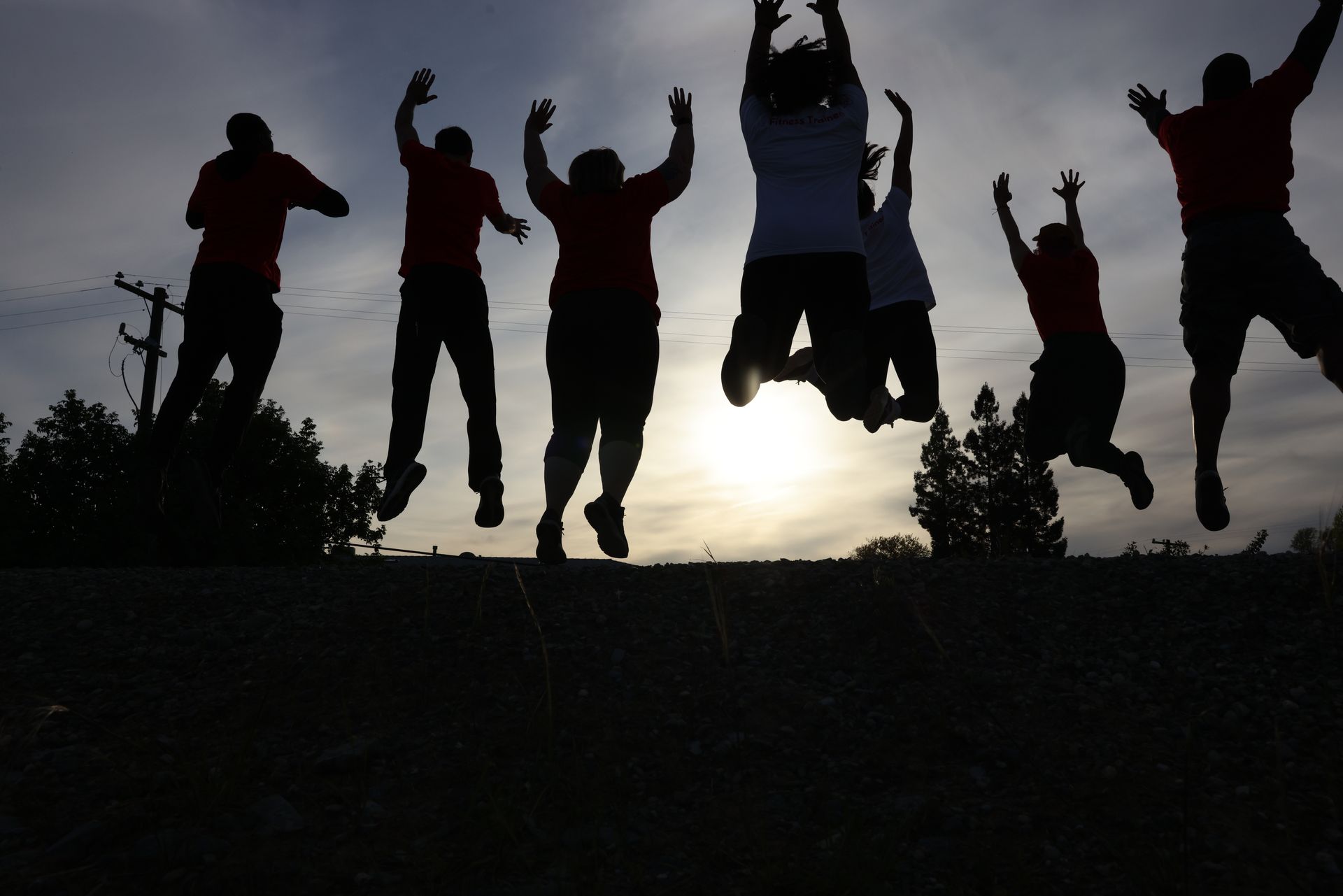 A group of people are jumping in the air with their arms in the air