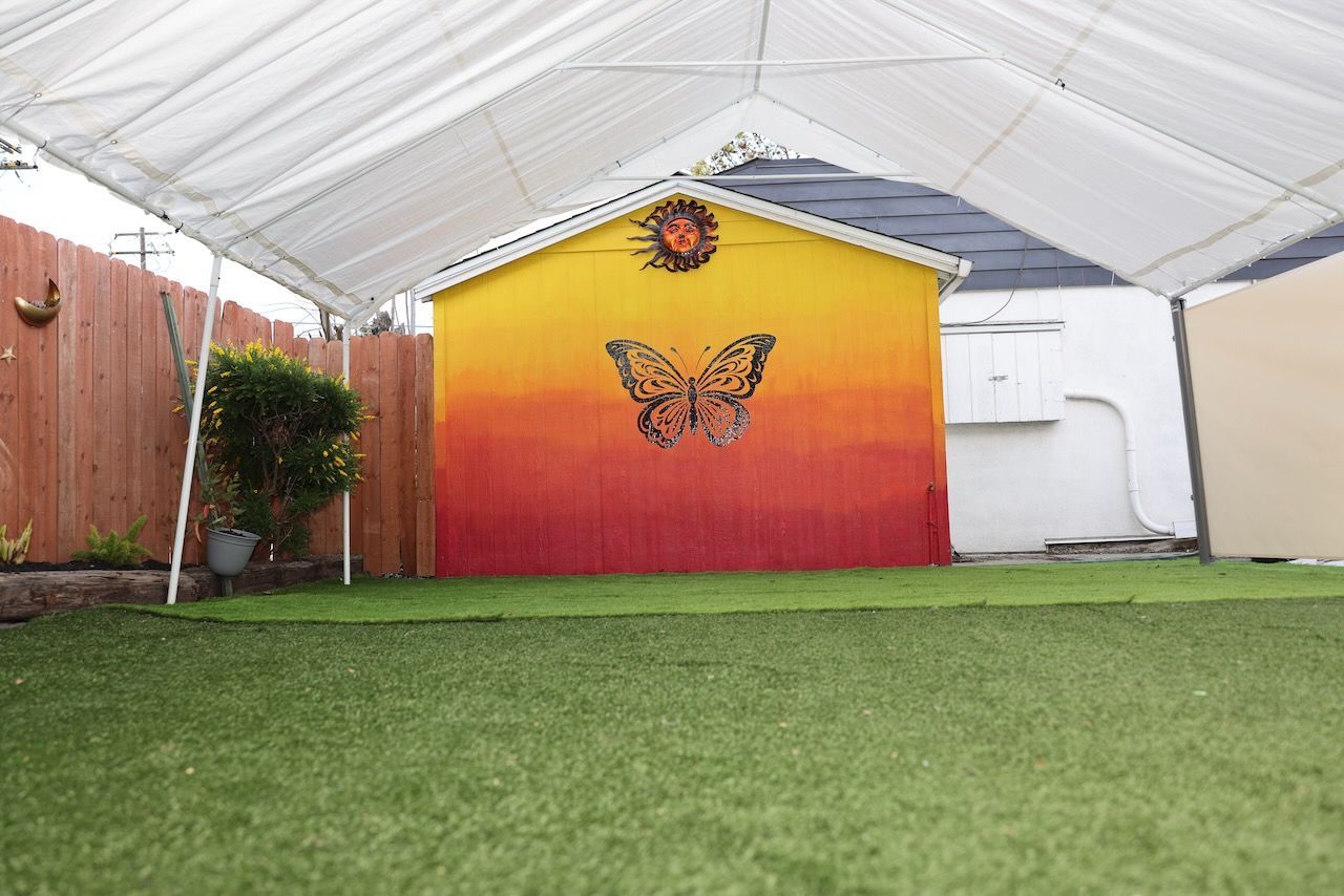 A butterfly is painted on the side of a building.