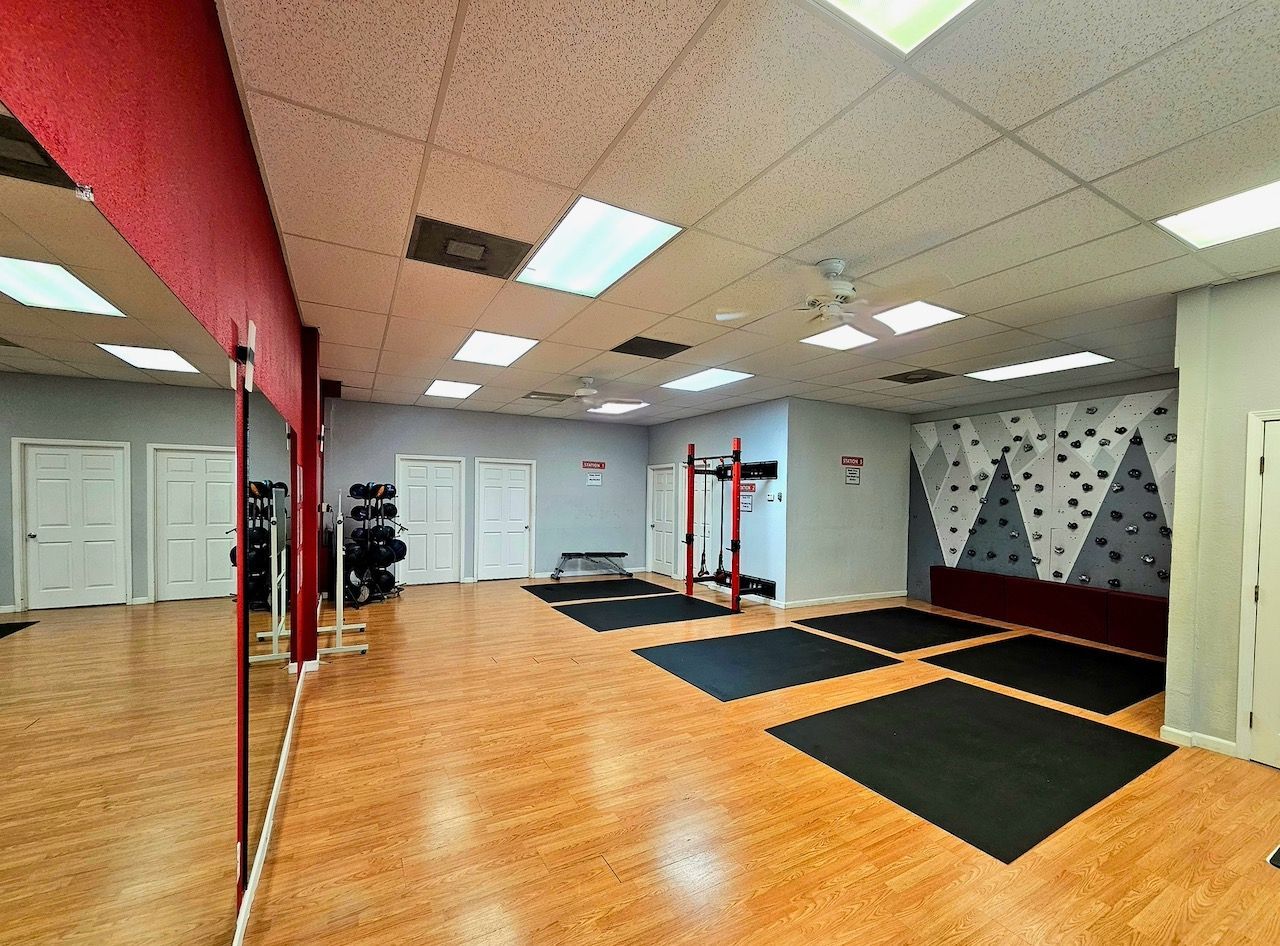 A patio area with a canopy and exercise equipment