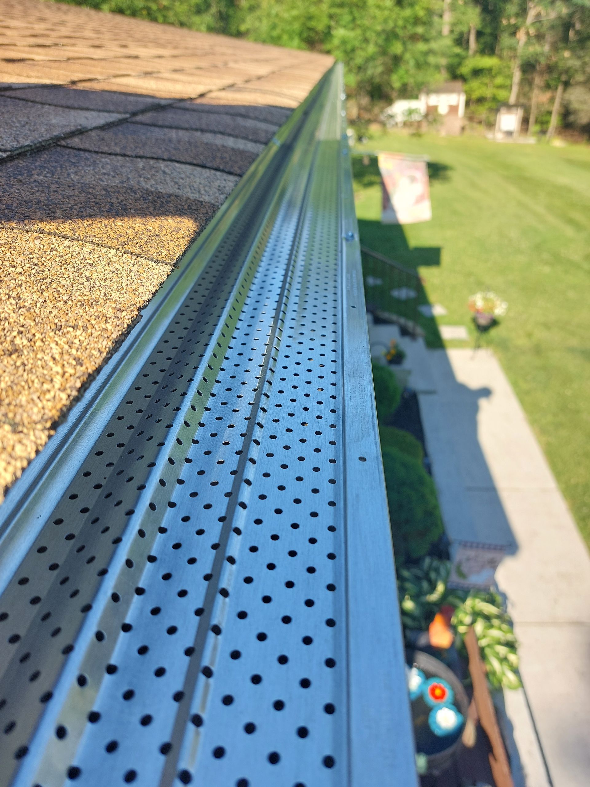 A brick building with a white roof and a bay window