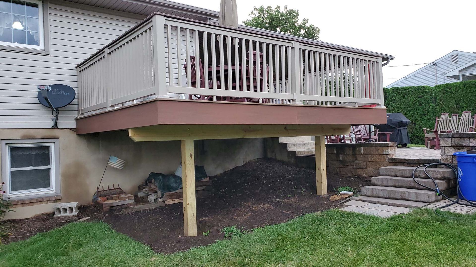 A deck is being built in the backyard of a house.