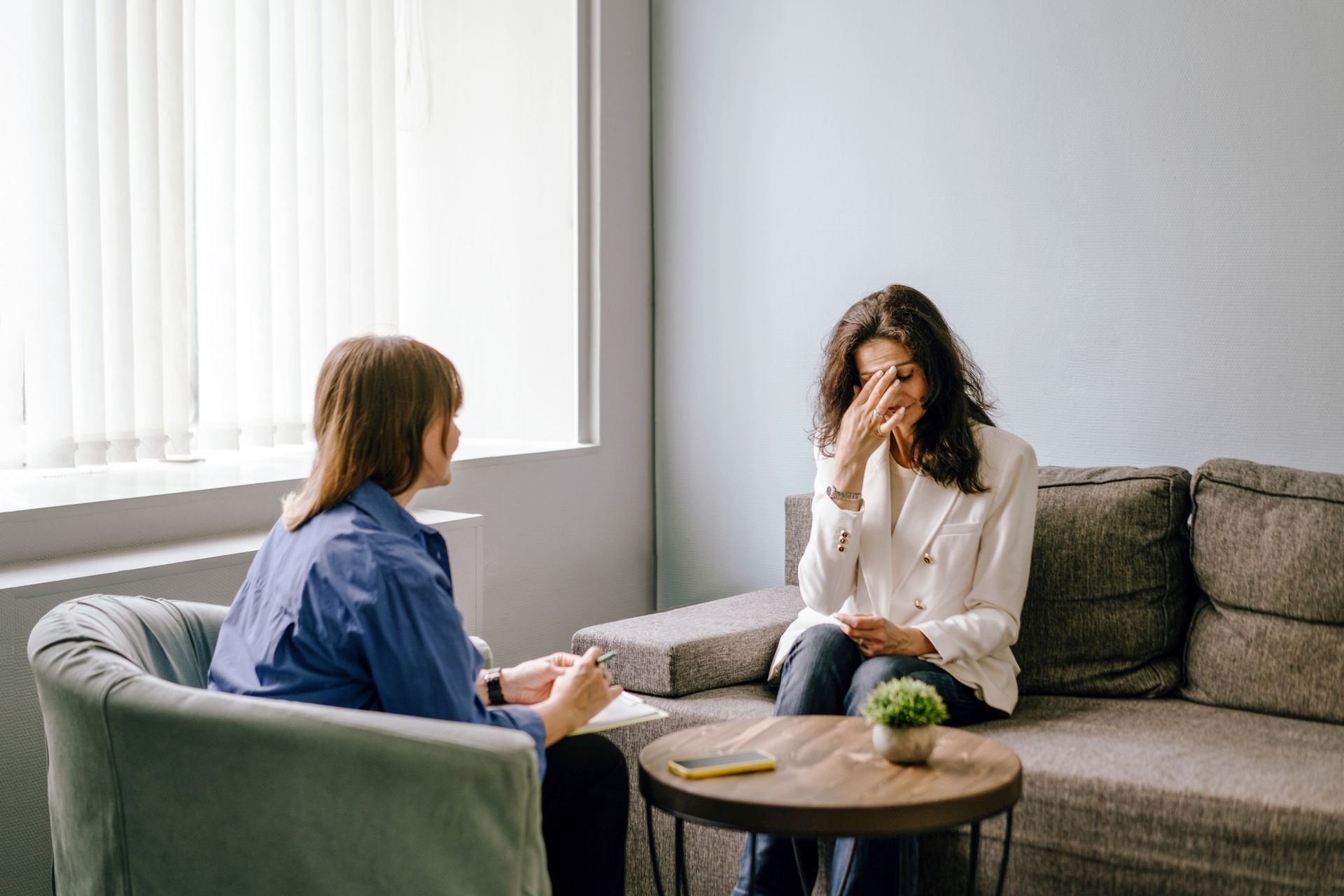 Woman in distress during therapy session with a therapist.