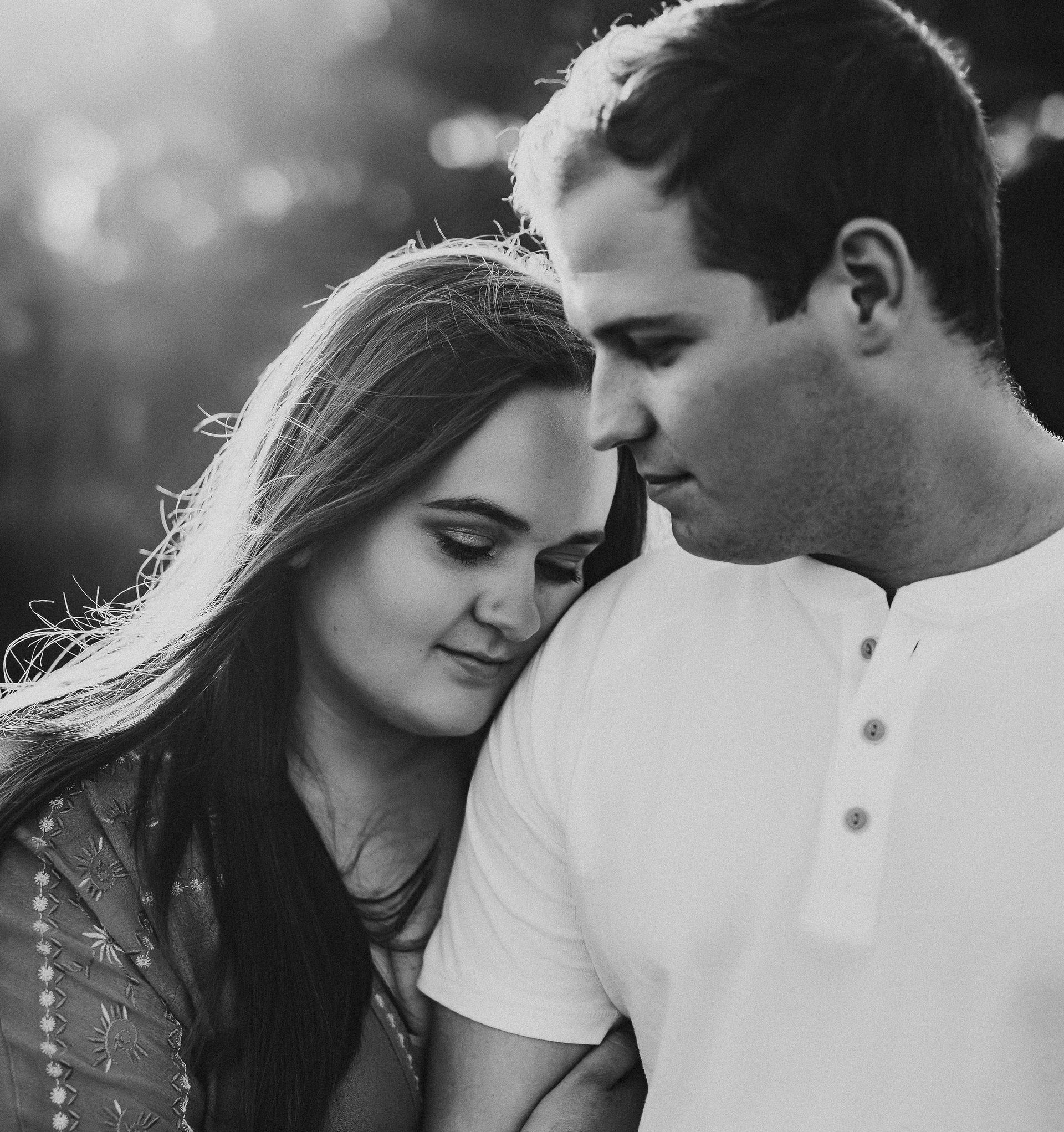 Black and white photo of Studio Huff founders Joey and Hayley hugging.