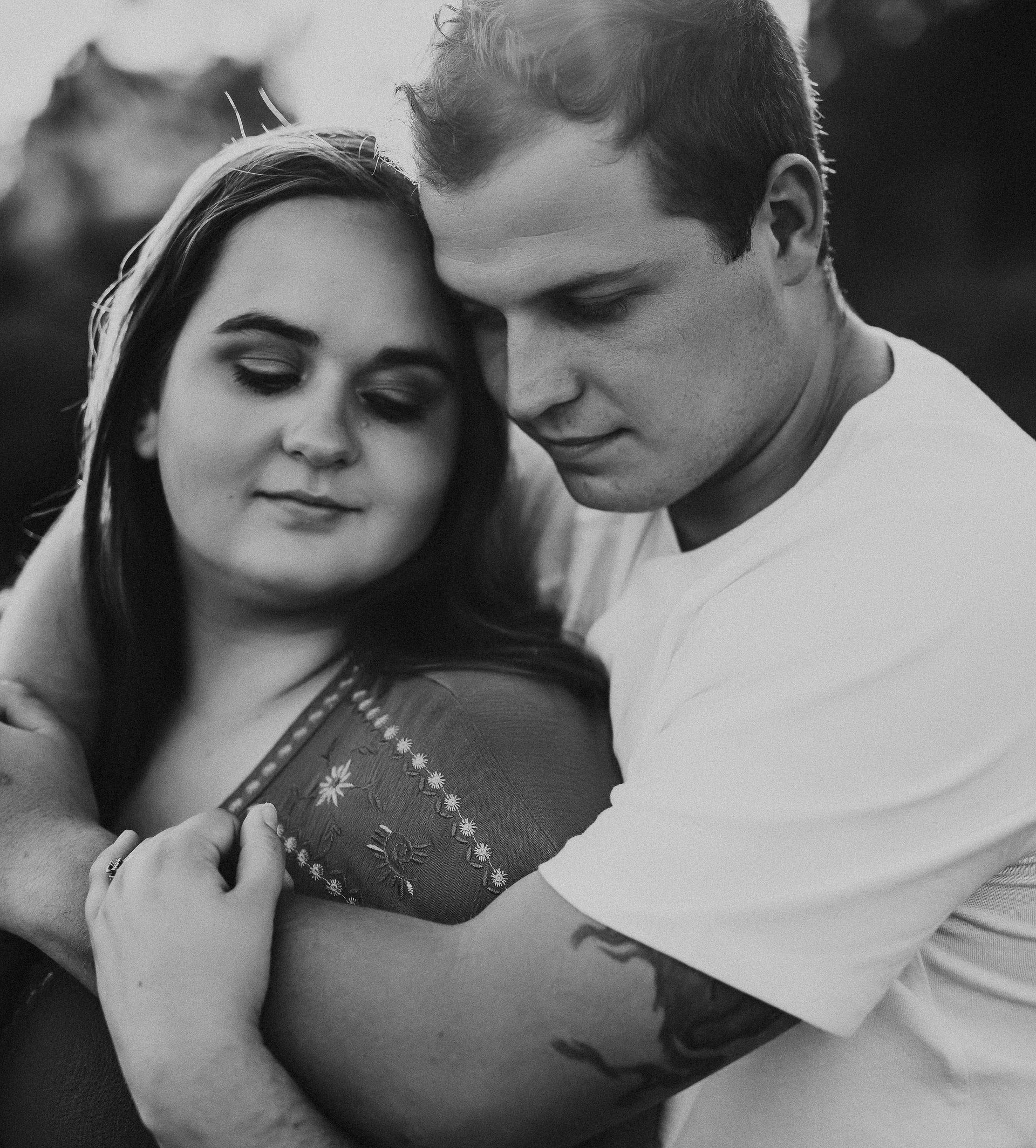 Black and white photo of Studio Huff founders Joey and Hayley hugging.