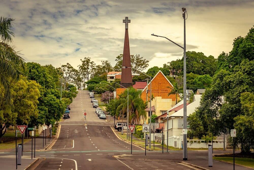 A Street in a Town With a Church Steeple at the Top of the Hill — Central Scrap Metal in Ipswich, QLD