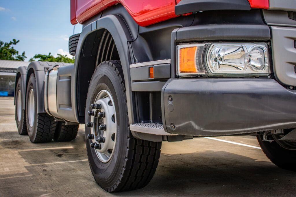 A Red and Black Semi-truck's Front and Wheels, Parked on Concrete — Central Scrap Metal in Willawong, QLD