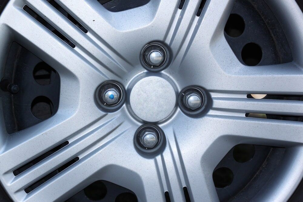 A Silver Car Hubcap With a Star-like Design, Showing Wheel — Central Scrap Metal in Willawong, QLD
