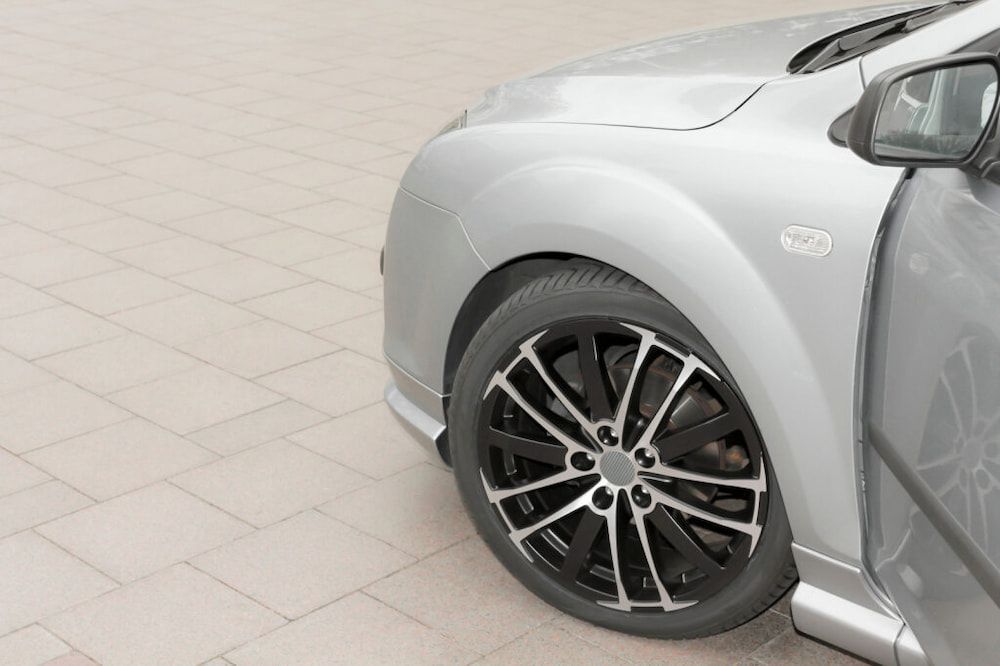Silver Car's Front, Showing Wheel With Black and Silver Rims — Central Scrap Metal in Willawong, QLD